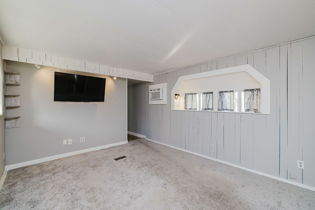 3040 Cranberry Highway, Unit 41 Wareham, MA 02538 - Photo 12 of 25 a view of an empty room with a flat screen tv