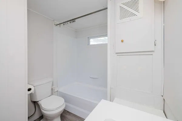 a bath room with a toilet and a bath tub