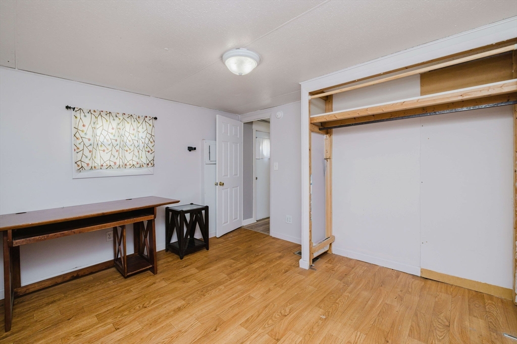 3040 Cranberry Highway, Unit 41 Wareham, MA 02538 - Photo 17 of 25 a view of empty room with wooden floor and fan