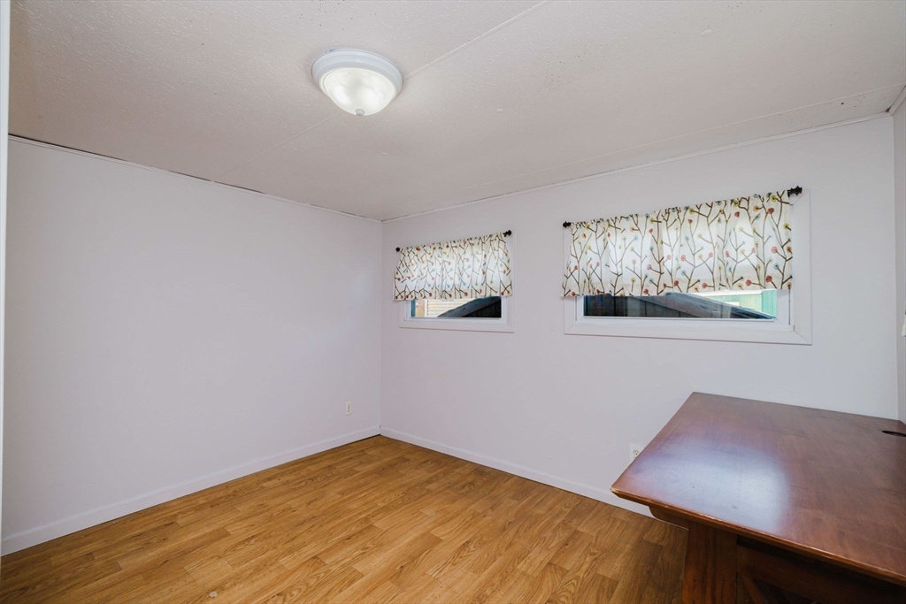 3040 Cranberry Highway, Unit 41 Wareham, MA 02538 - Photo 18 of 25 a view of a room with wooden floor and window