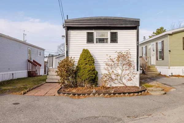 a view of a house with a yard and garage