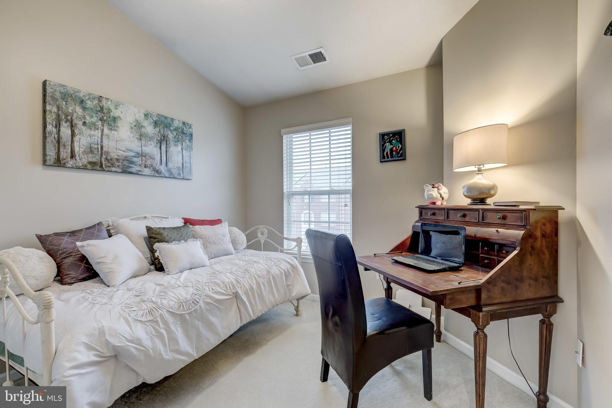 9727 Biggs Road Baltimore, MD 21220 - Photo 24 of 35 a bedroom with a bed and a table in it