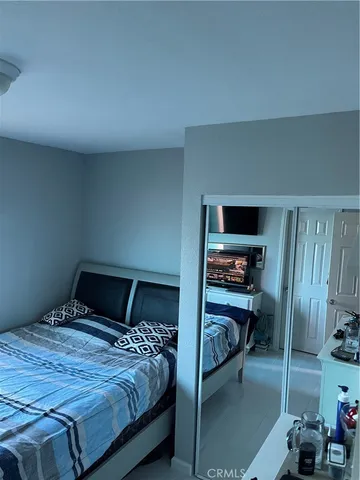 a bedroom with a bed and a closet