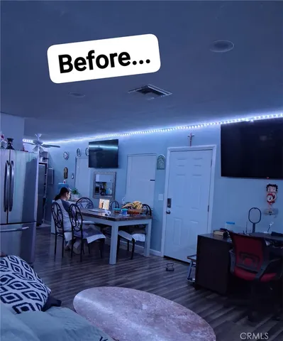 a living room with couches and a flat screen tv