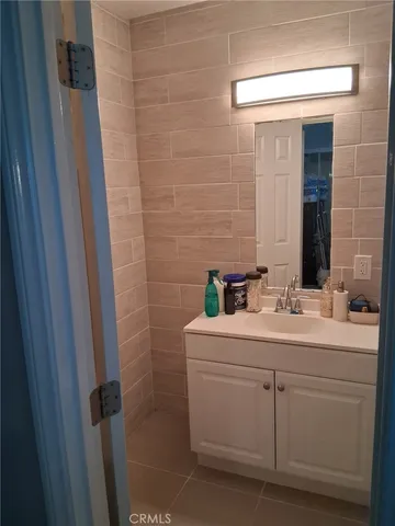 a bathroom with a double vanity sink and mirror