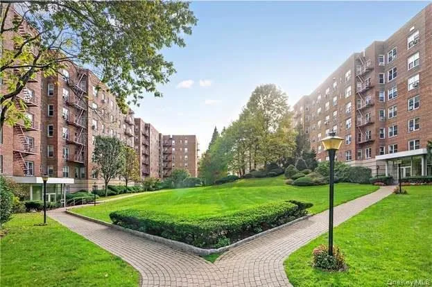 a view of a big building with a big yard and plants