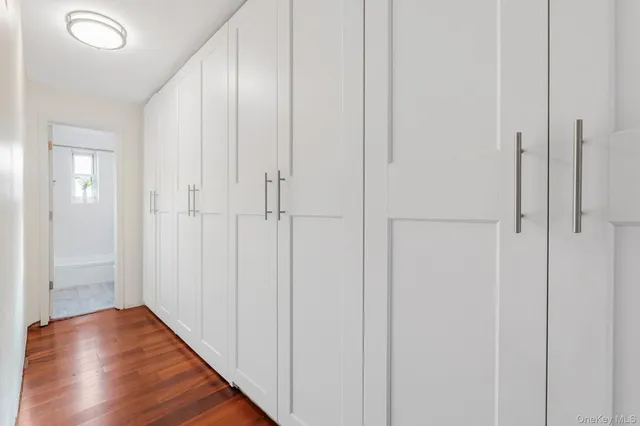 a view of a hallway with wooden floor
