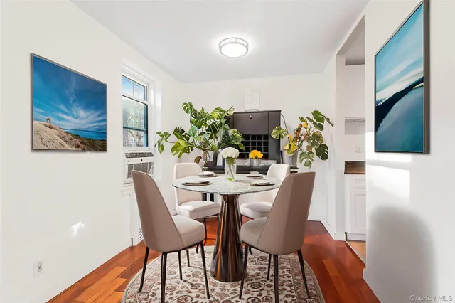 a dining room with furniture and wooden floor