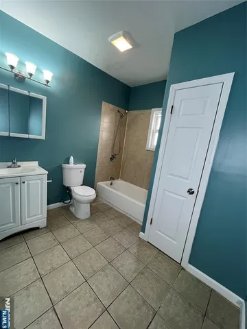 a bathroom with a sink a toilet a mirror and vanity
