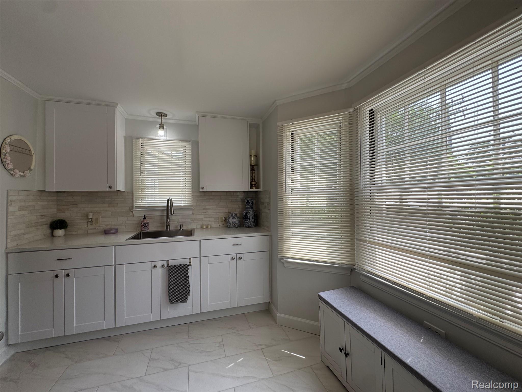 2452 Earlmont Road Berkley, MI 48072 - Photo 6 of 27 Modern kitchen featuring white shaker cabinetry, quartz countertops, a tile backsplash, and a stainless steel sink with a gooseneck faucet