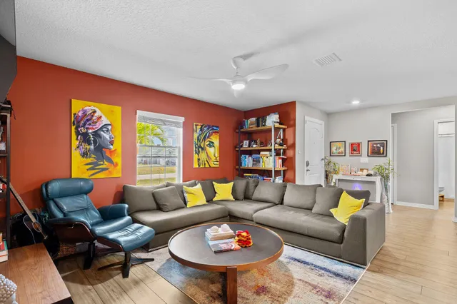 a living room with furniture a rug and a large window