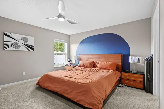 a bedroom with a large bed and a chandelier