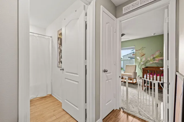 a view of a hallway with a livingroom and entryway