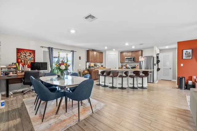 a view of a dining room with furniture and wooden floor