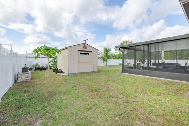 a backyard of a house with table and chairs