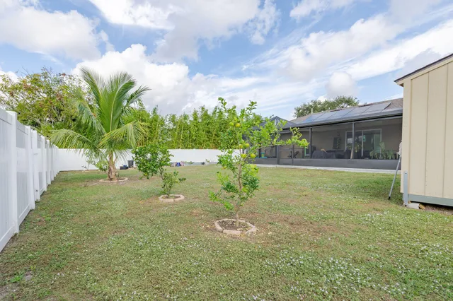 a backyard of a house with table and chairs