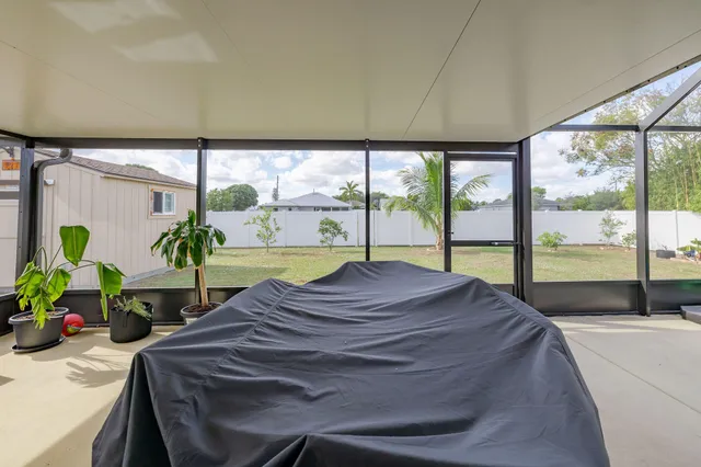 a bed sitting in a bedroom next to a large window