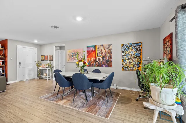 a view of a dining room with furniture and wooden floor