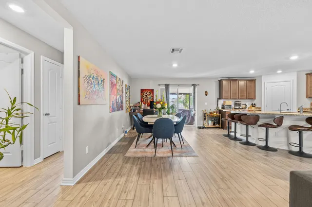 a living room with furniture a wooden floor and a window