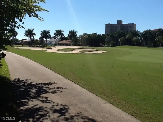 an aerial view of a golf course with a lake view