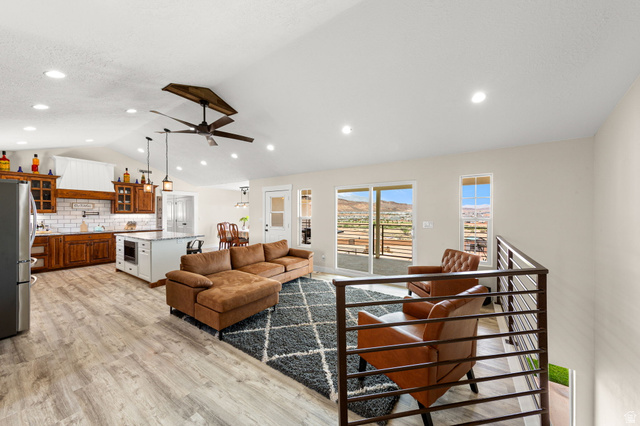 2591 East Washington Dam Road Washington, UT 84780 - Photo 7 of 67 Open-concept living space featuring wood-finish flooring, a vaulted ceiling with recessed lighting, and a modern ceiling fan