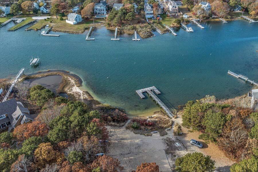 45 Manitoba Road Mashpee, MA 02649 - Photo 25 of 34 an aerial view of a house with a yard and lake view