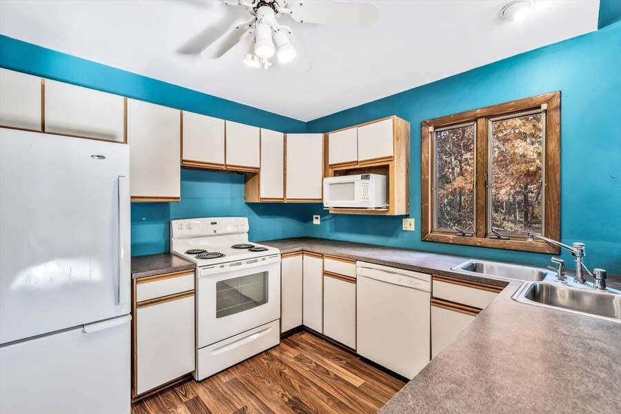 45 Manitoba Road Mashpee, MA 02649 - Photo 5 of 34 a kitchen with white cabinets and white appliances