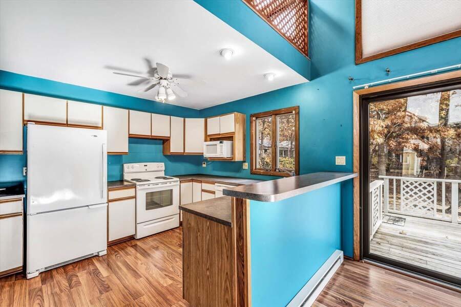45 Manitoba Road Mashpee, MA 02649 - Photo 6 of 34 a kitchen with white cabinets and white appliances