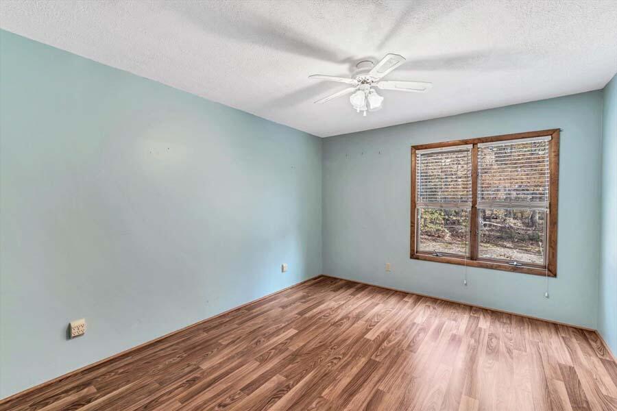 45 Manitoba Road Mashpee, MA 02649 - Photo 8 of 34 an empty room with wooden floor fan and windows