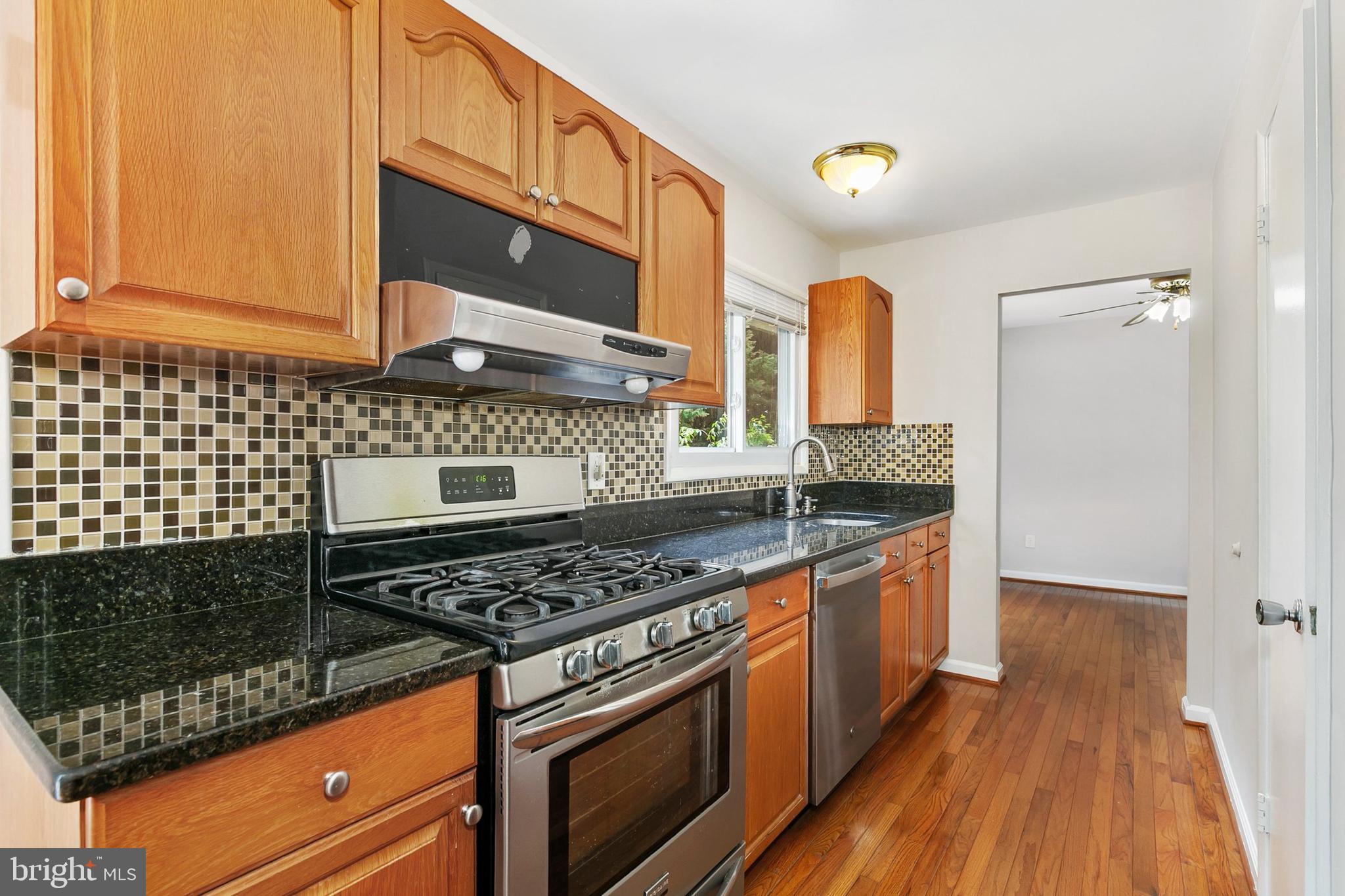 11501 Piney Lodge Road North Potomac, MD 20878 - Photo 14 of 64 a kitchen with stainless steel appliances granite countertop a stove a sink and a microwave