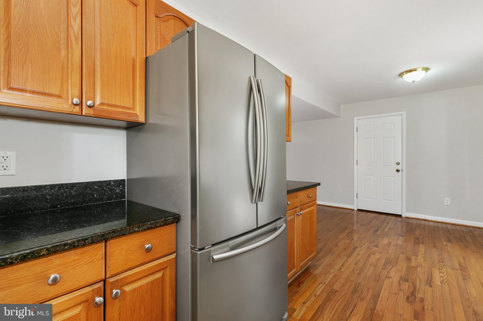 11501 Piney Lodge Road North Potomac, MD 20878 - Photo 16 of 64 a kitchen with stainless steel appliances granite countertop a refrigerator and a stove top oven