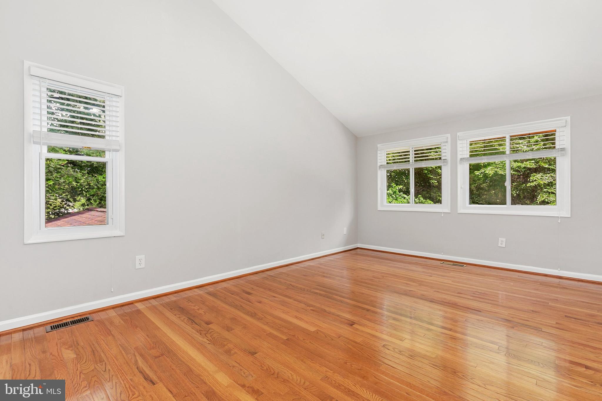 11501 Piney Lodge Road North Potomac, MD 20878 - Photo 22 of 64 an empty room with wooden floor and windows
