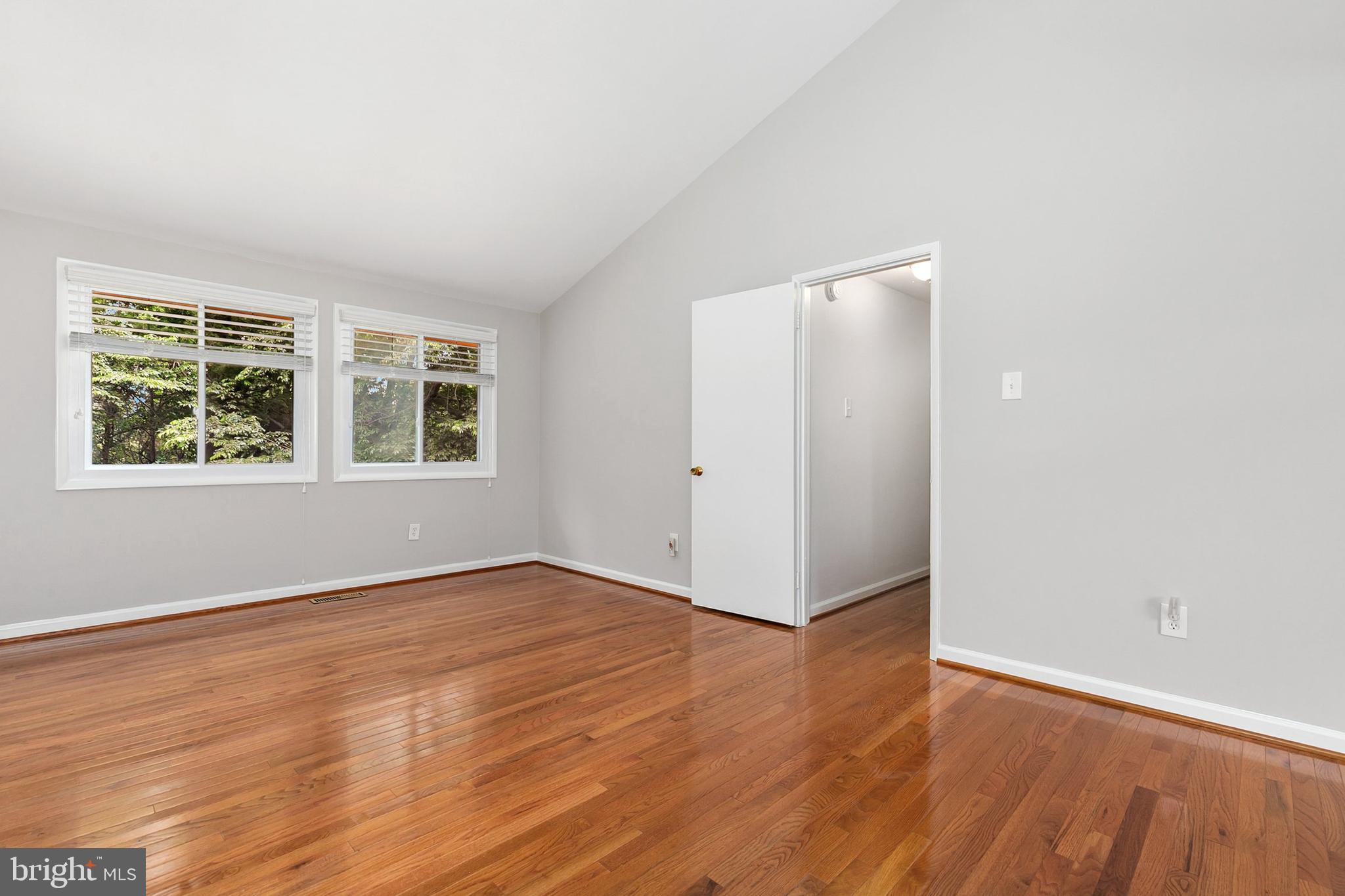 11501 Piney Lodge Road North Potomac, MD 20878 - Photo 23 of 64 an empty room with wooden floor and windows