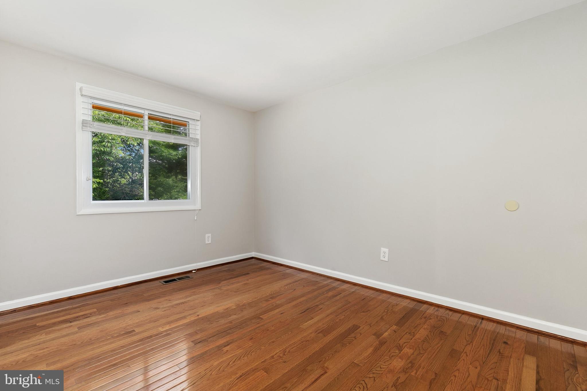 11501 Piney Lodge Road North Potomac, MD 20878 - Photo 29 of 64 wooden floor in an empty room with a window