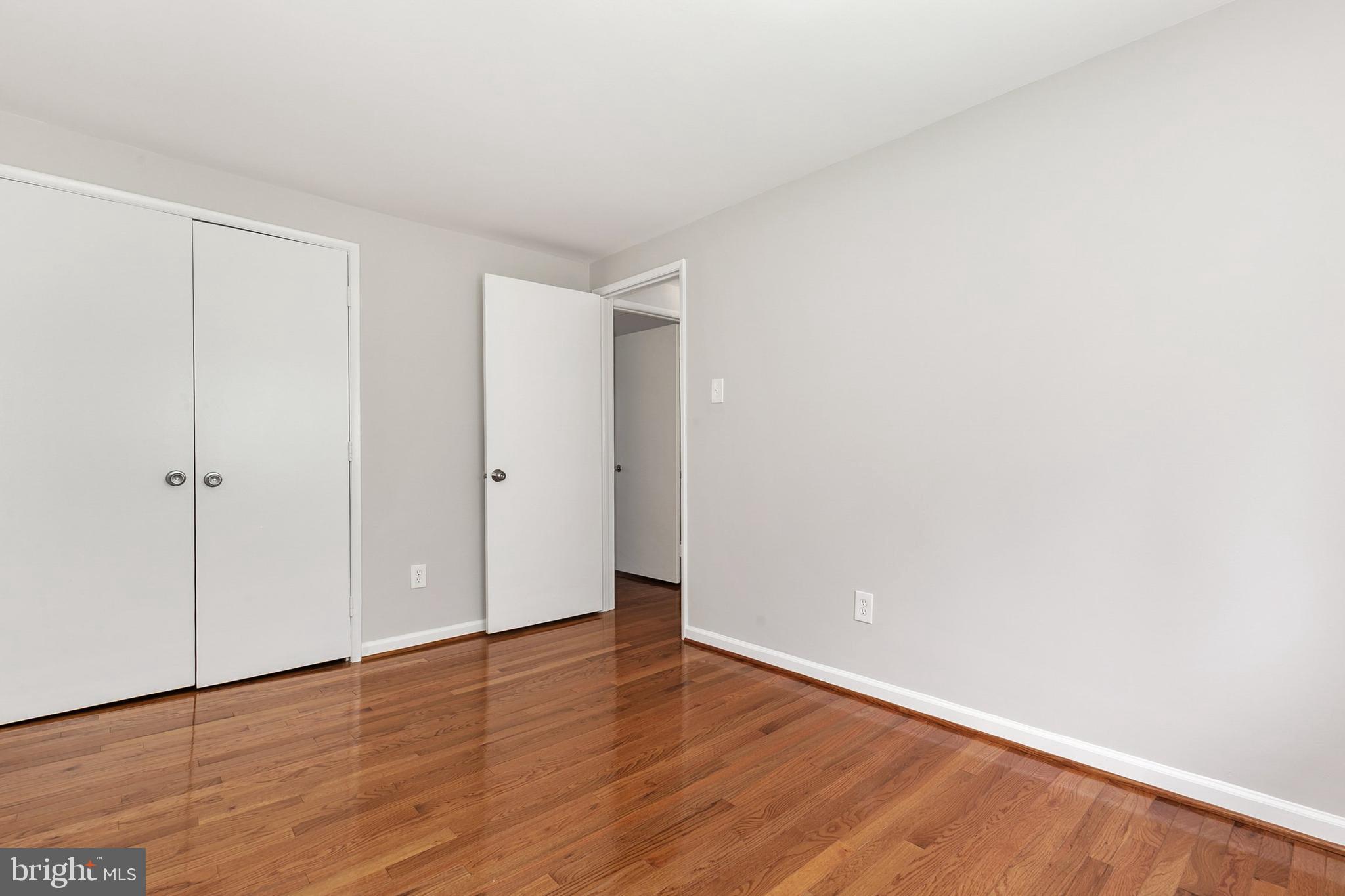 11501 Piney Lodge Road North Potomac, MD 20878 - Photo 30 of 64 a view of an empty room with wooden floor