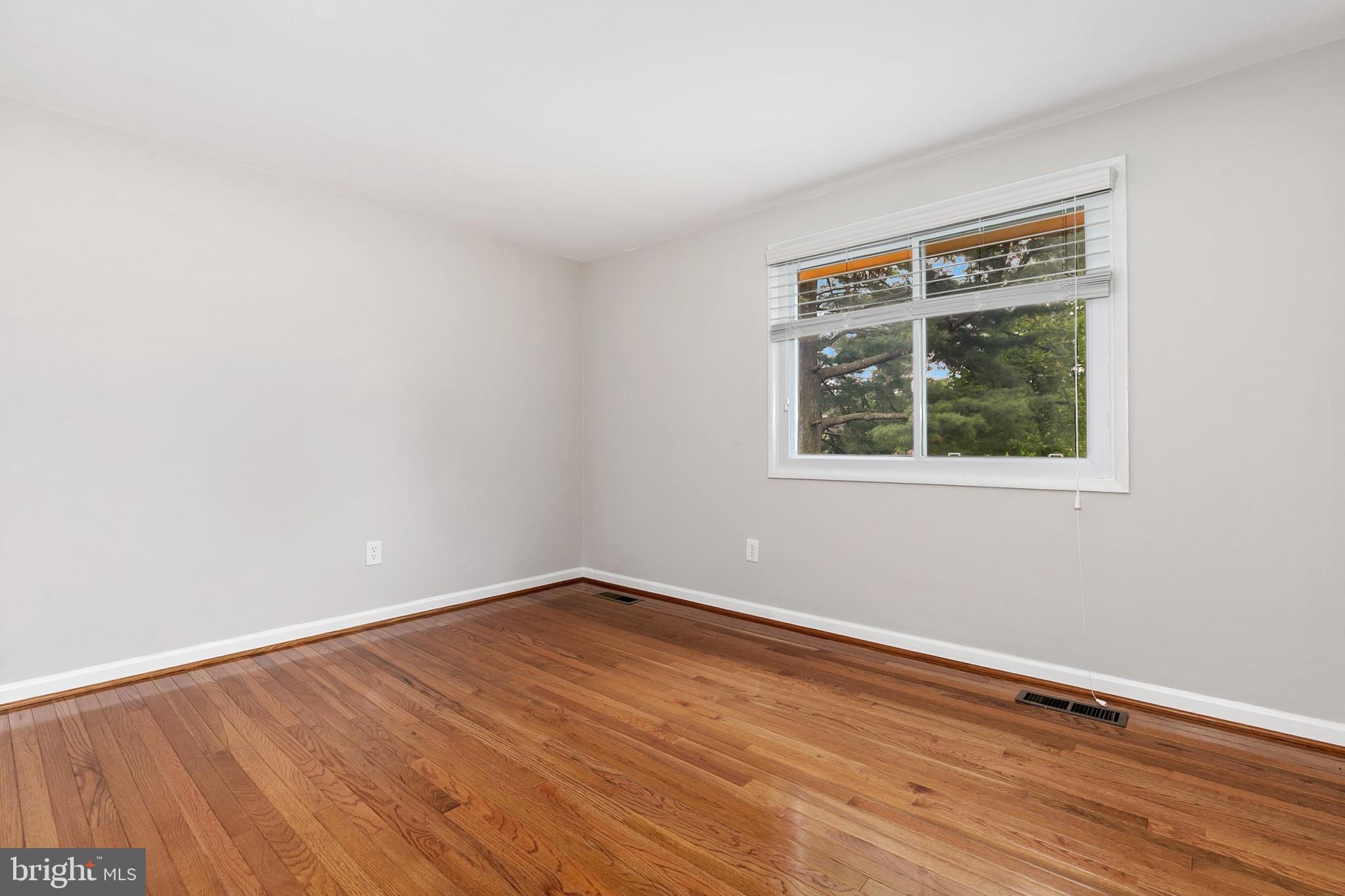 11501 Piney Lodge Road North Potomac, MD 20878 - Photo 31 of 64 a view of an empty room with wooden floor and a window
