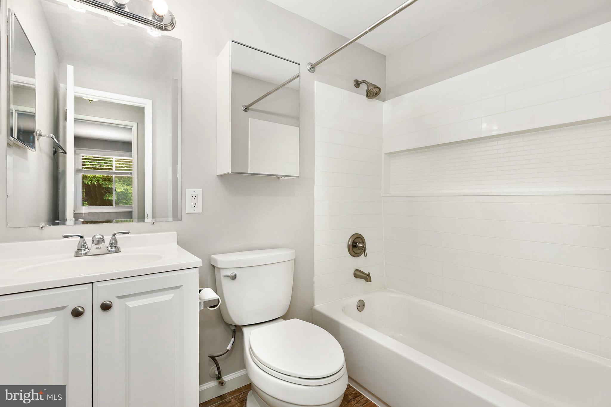 11501 Piney Lodge Road North Potomac, MD 20878 - Photo 34 of 64 a white toilet sitting next to a bathroom sink