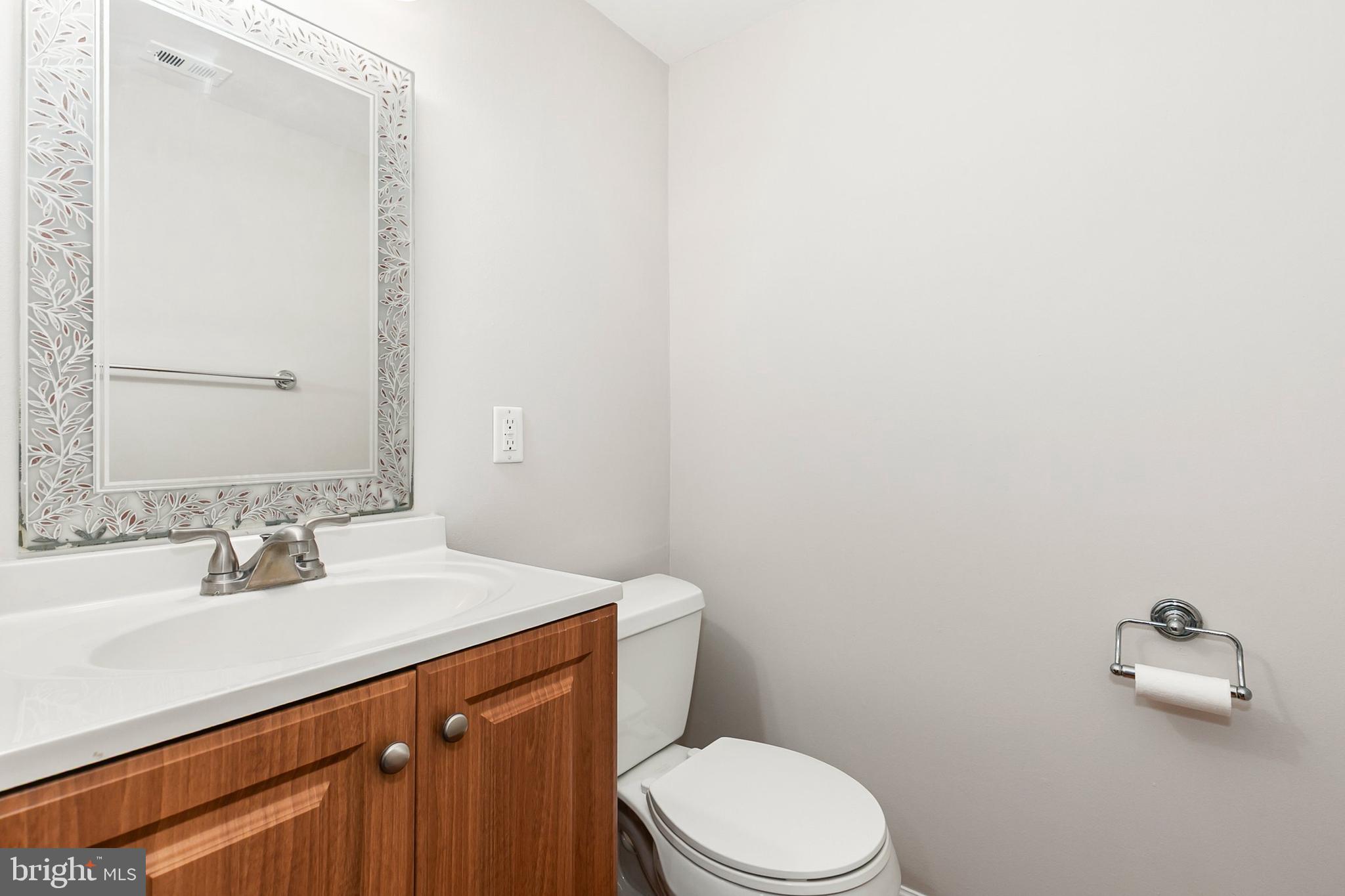 11501 Piney Lodge Road North Potomac, MD 20878 - Photo 36 of 64 a bathroom with a sink a toilet and mirror