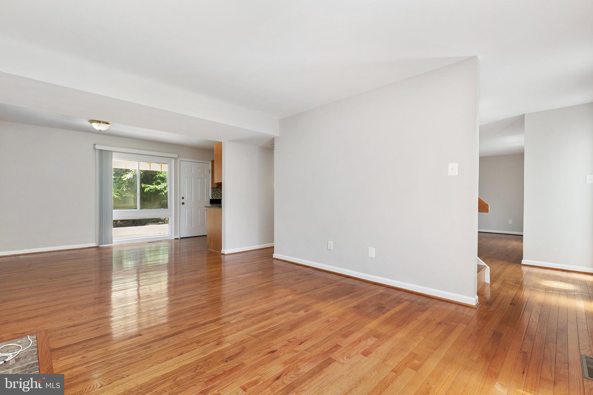 11501 Piney Lodge Road North Potomac, MD 20878 - Photo 4 of 64 a view of an empty room with wooden floor and a window