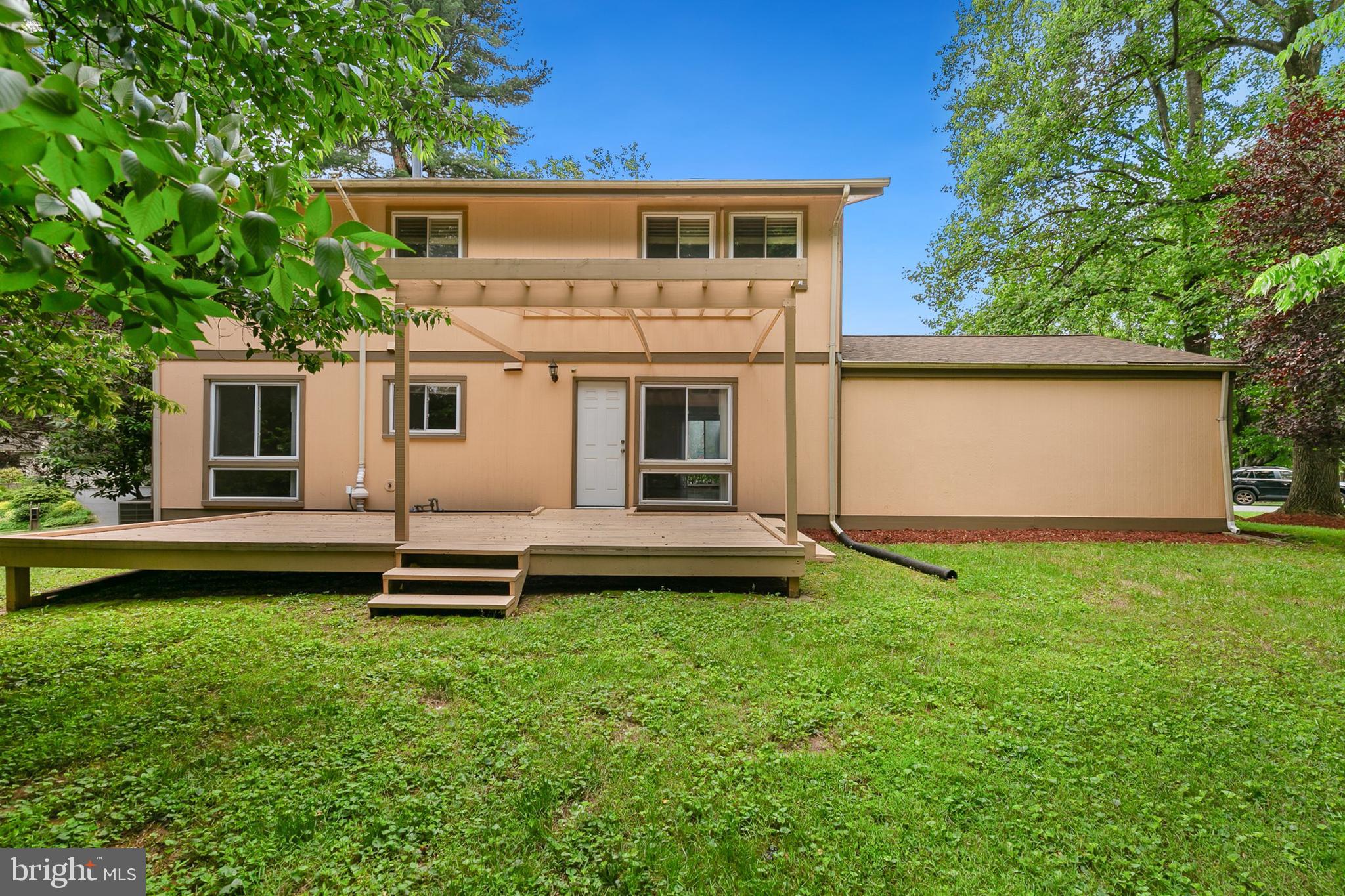 11501 Piney Lodge Road North Potomac, MD 20878 - Photo 45 of 64 a front view of a house with a garden