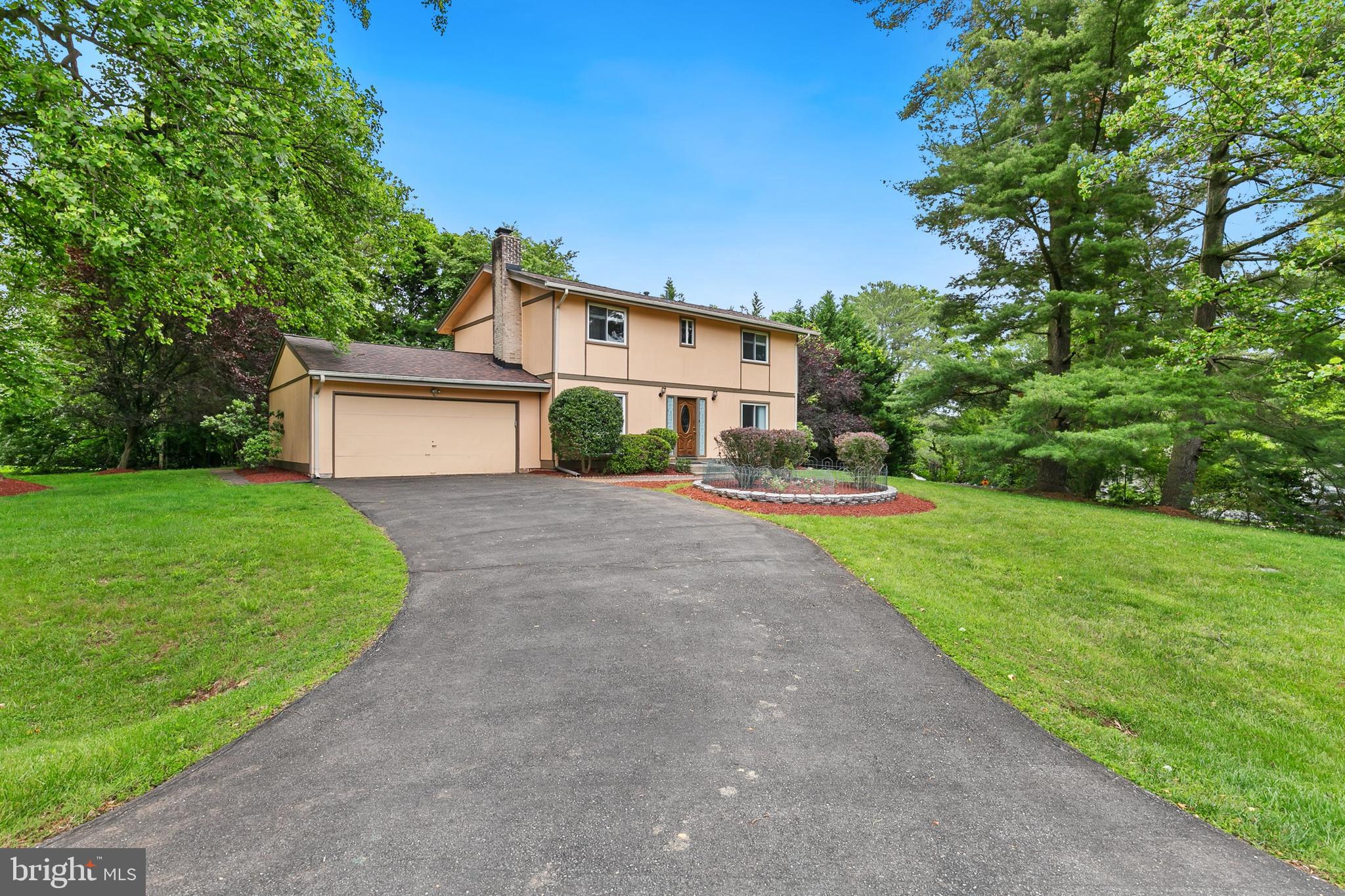 11501 Piney Lodge Road North Potomac, MD 20878 - Photo 49 of 64 a front view of a house with a yard and garage