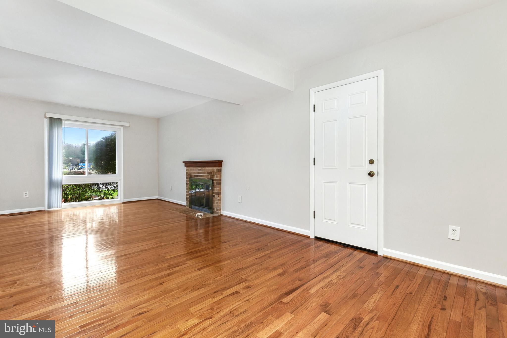 11501 Piney Lodge Road North Potomac, MD 20878 - Photo 5 of 64 a view of empty room with wooden floor and fan