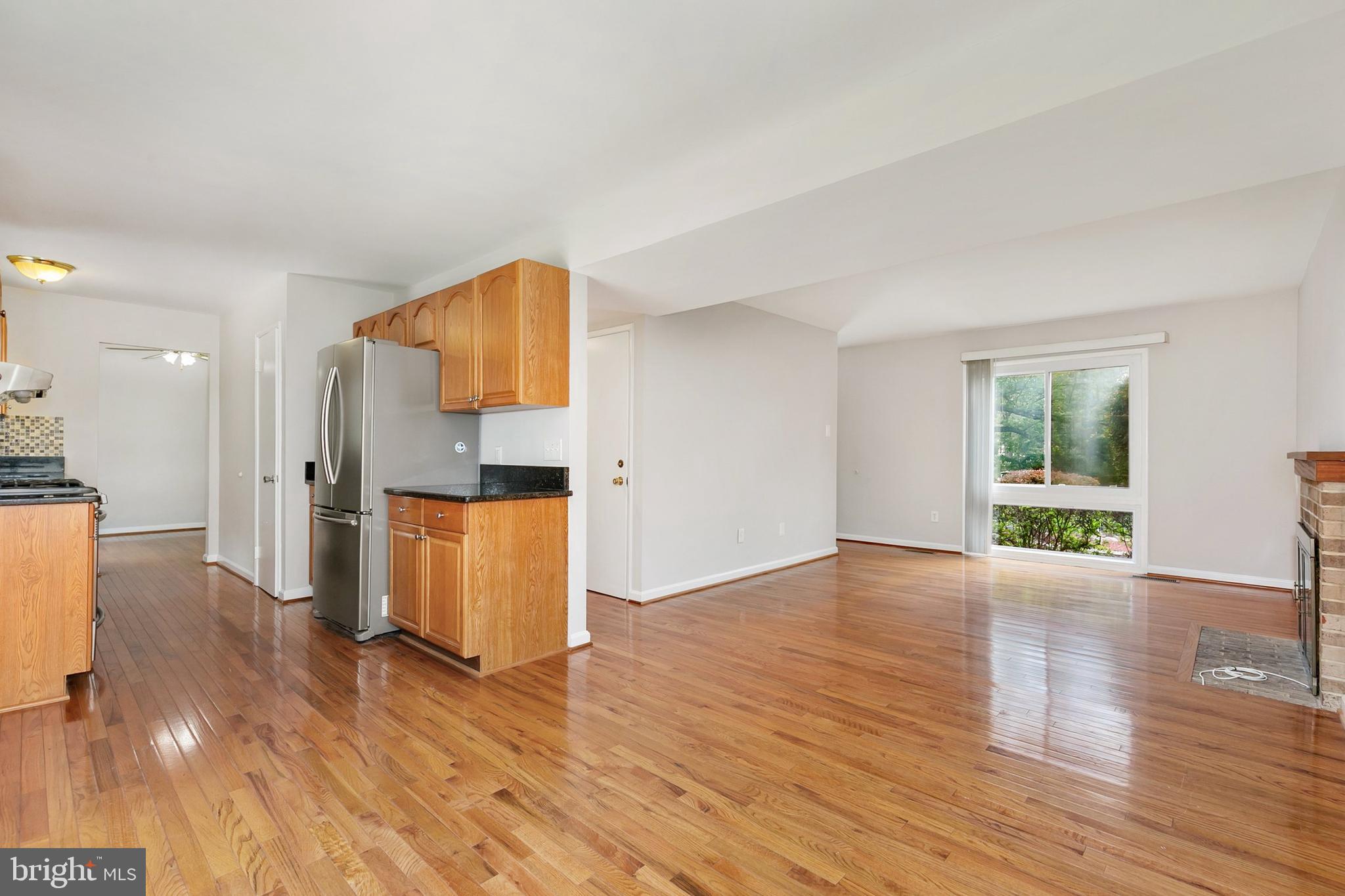 11501 Piney Lodge Road North Potomac, MD 20878 - Photo 9 of 64 a view of empty room with wooden floor and window