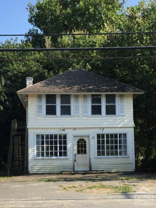 a front view of a house with a garden