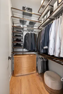 a view of walk in closet with clothes and shoes