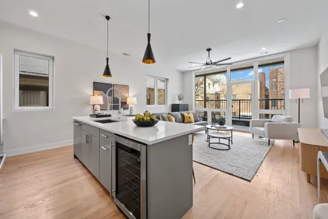 a kitchen with stainless steel appliances granite countertop a sink a stove and a wooden floors