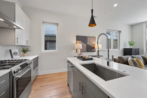a kitchen that has a sink and a stove