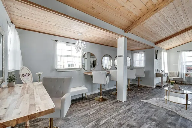 a living room with couches chair and a large window with garden view