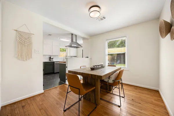 a view of a dining room with furniture and wooden floor