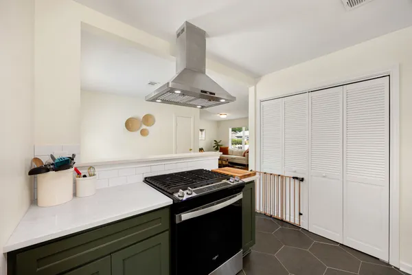 a kitchen with a stove and a refrigerator
